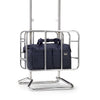 Navy blue Samsonite bag in a metal stand on a white background