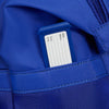 Blue Samsonite backpack with a name tag pocket containing a name tag.