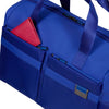 Blue Samsonite duffel bag with a red item inside on a white background