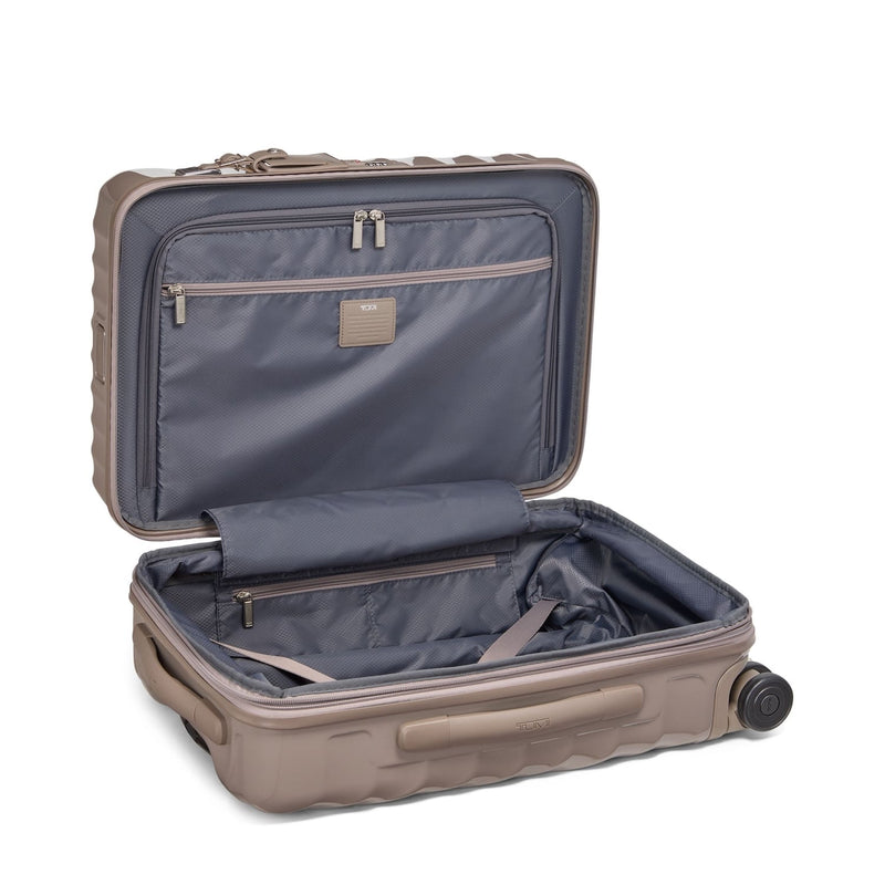 Open beige TUMI suitcase with blue interior on a white background