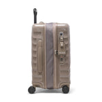 Beige TUMI suitcase on a white background
