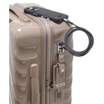 Beige TUMI suitcaseon a white background