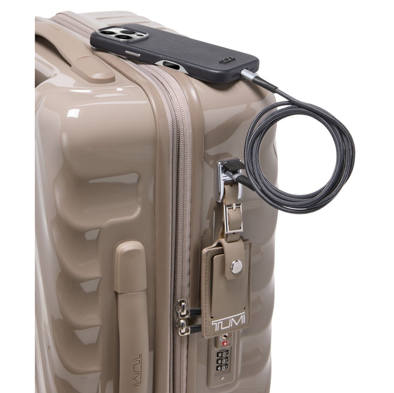 Beige TUMI suitcaseon a white background