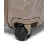 Close-up of a beige TUMI suitcase with a black wheel on a white background