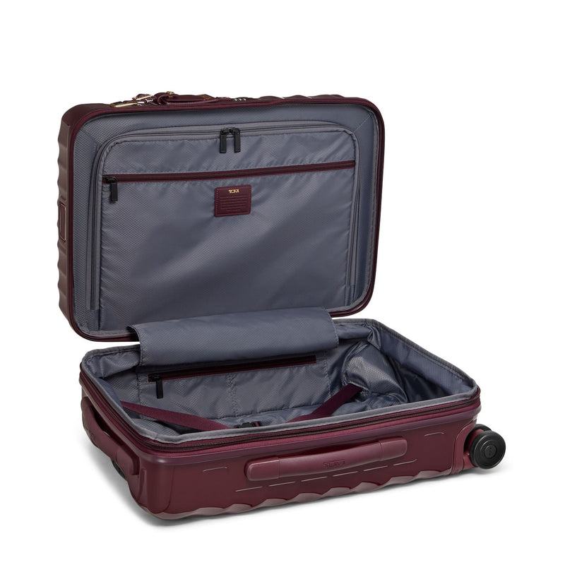 Open maroon TUMI suitcase with gray interior on a white background