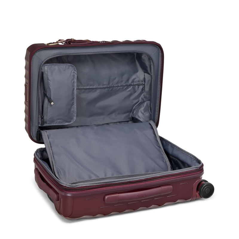 Open burgundy TUMI suitcase on a white background