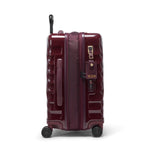 Maroon TUMI suitcase with wheels and handle on a white background