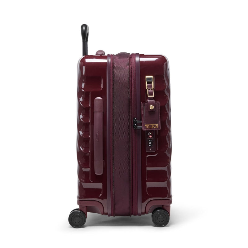 Maroon TUMI suitcase with wheels and handle on a white background