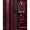Maroon TUMI suitcase with a luggage tag and handle