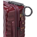 Maroon TUMI suitcase with a lock on a white background