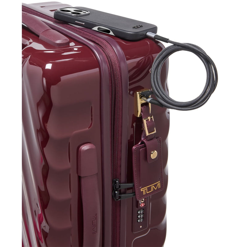 Maroon TUMI suitcase with a lock on a white background