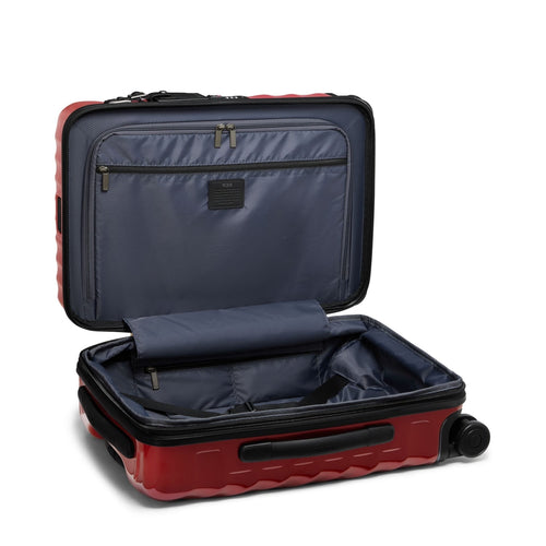 Red TUMI suitcase with open compartment on a white background