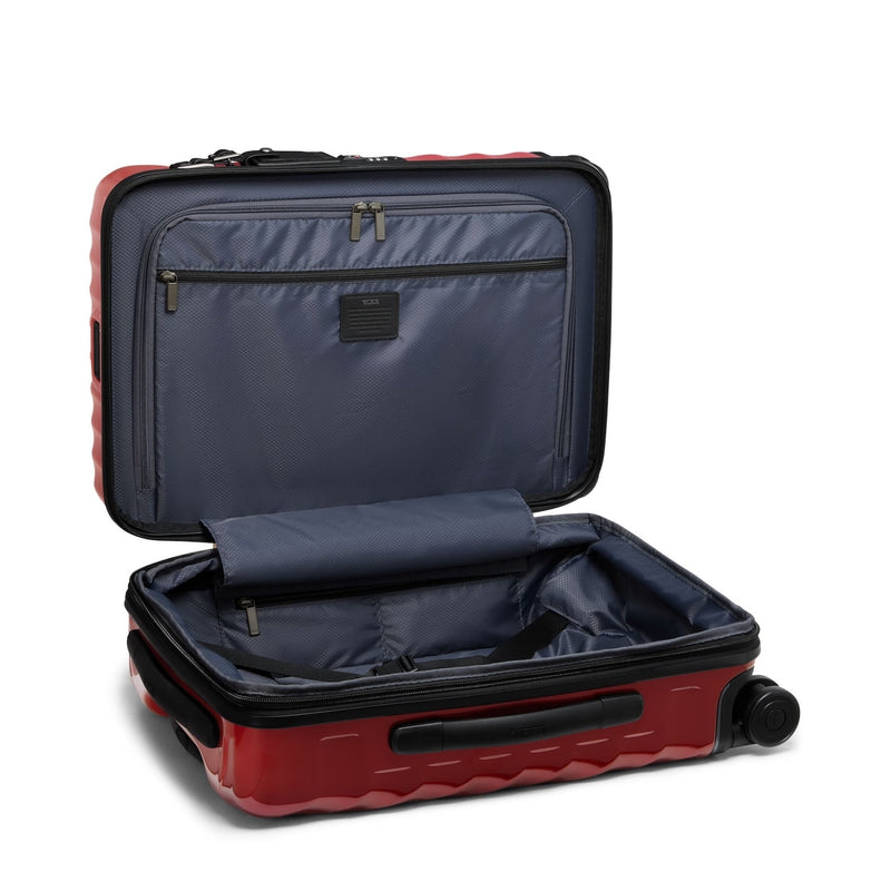 Red TUMI suitcase with open compartment on a white background