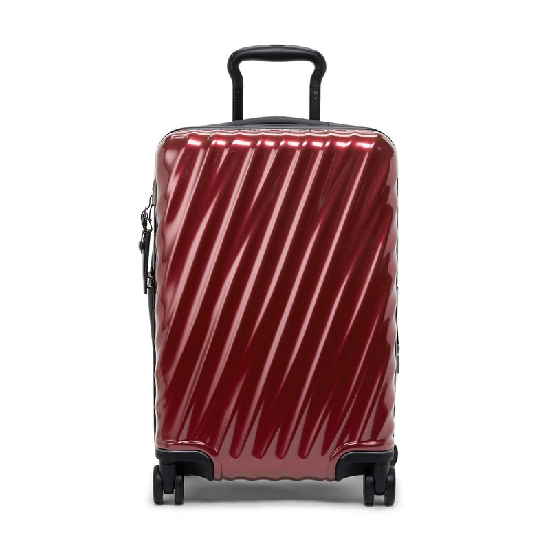 Red TUMI suitcase with black handle and wheels on a white background