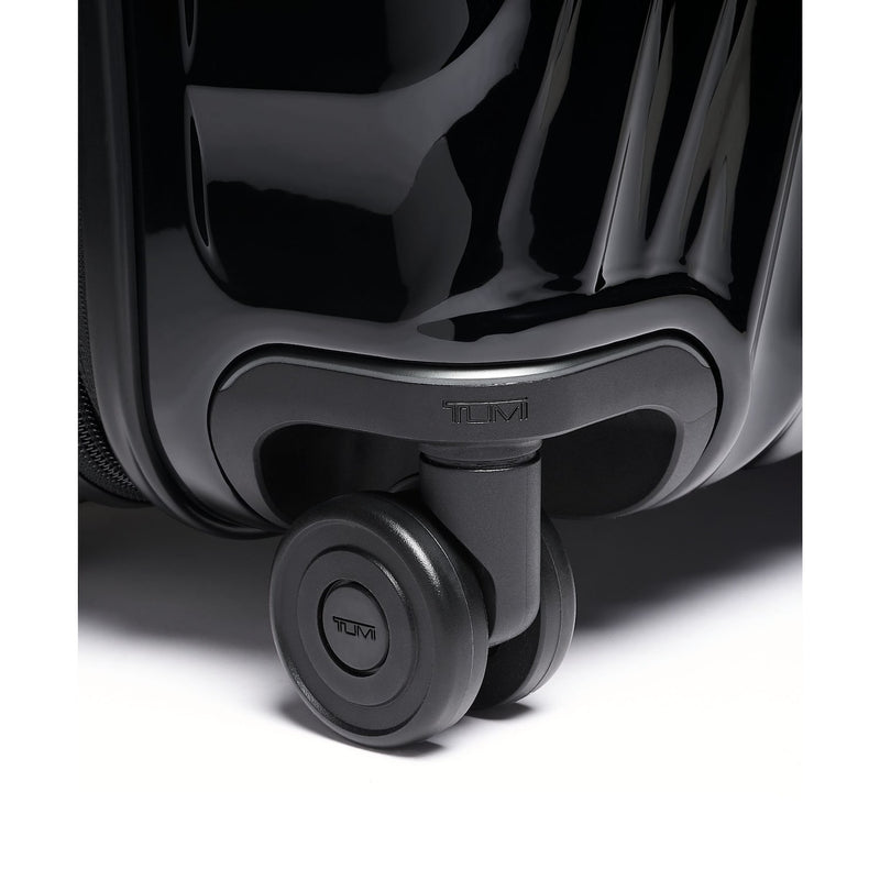 Close-up of a black TUMI suitcase with wheels on a white background