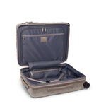 Open beige TUMI suitcase with a white background