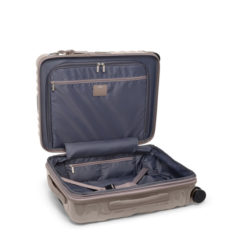 Open beige TUMI suitcase with a white background