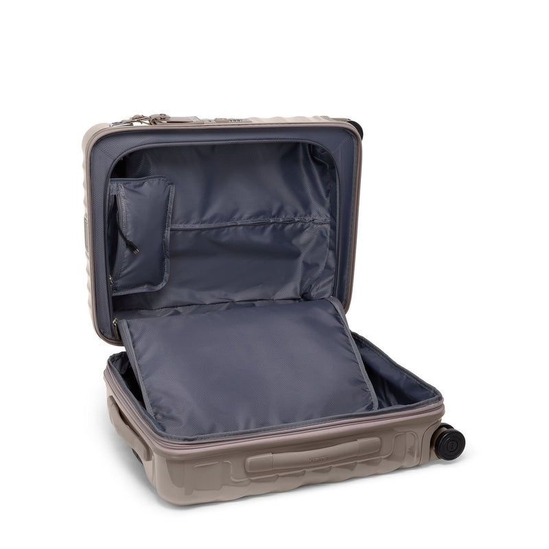 Open beige TUMI suitcase with dark interior on a white background