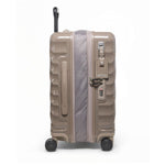 Beige TUMI suitcase with open zipper on a white background