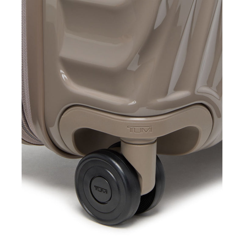 Close-up of a TUMI suitcase wheel on a white background