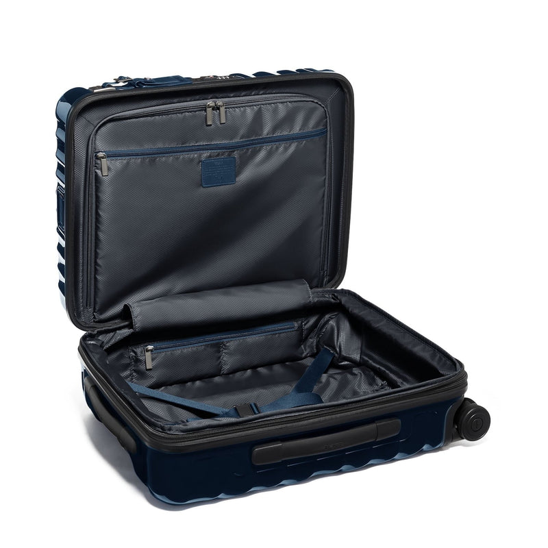 Open navy blue TUMI suitcase on a white background