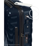 Navy TUMI suitcase with USB port and phone on top