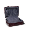 Open burgundy TUMI suitcase on a white background