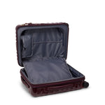 Open burgundy TUMI suitcase on a white background
