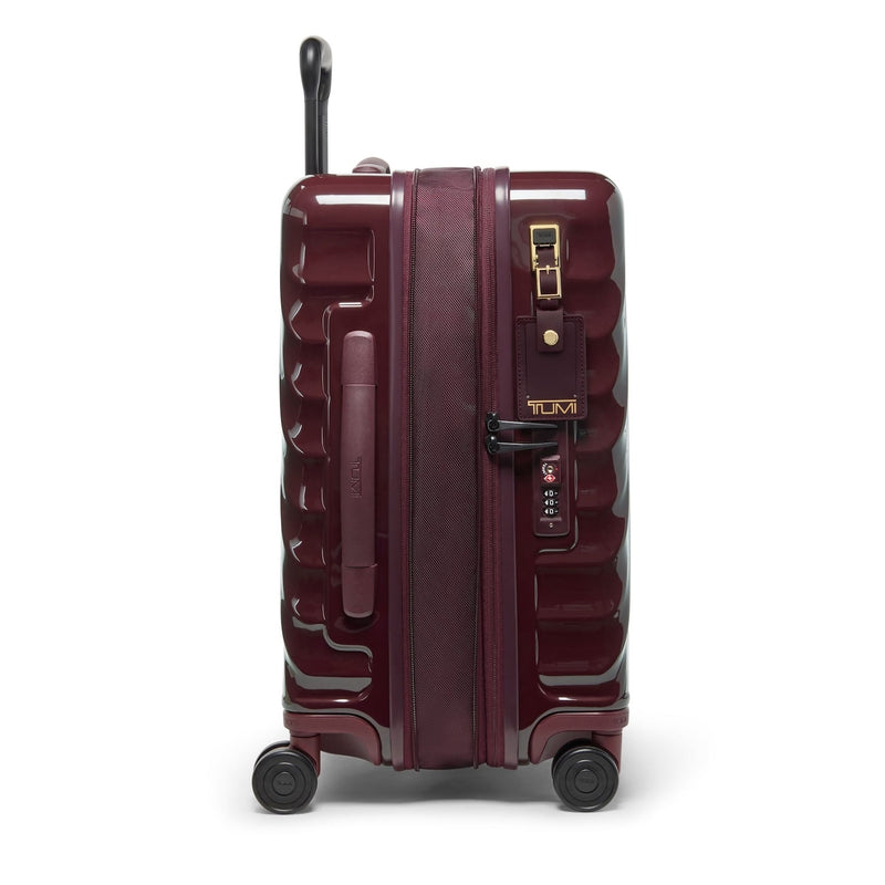 Maroon TUMI suitcase with gold accents on a white background
