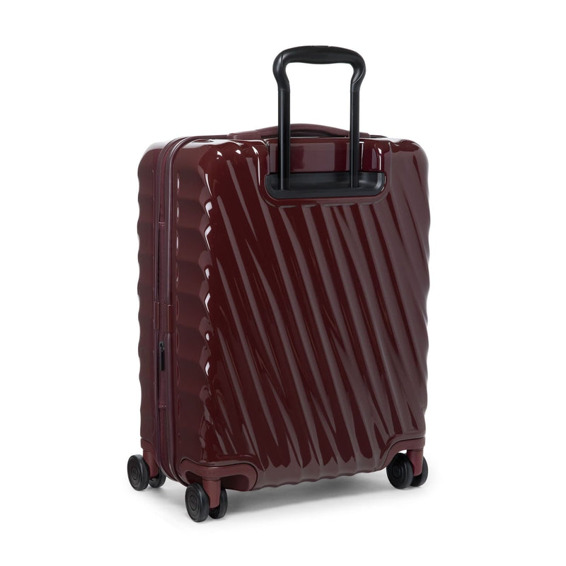 Maroon TUMI suitcase with a black handle on a white background