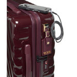 Maroon TUMI suitcase with a security cable and device attached on a white background