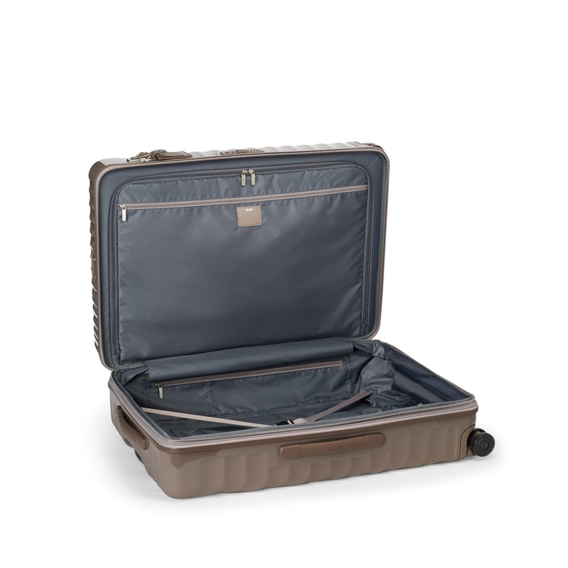 Open beige TUMI suitcase on a white background