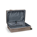 Open beige TUMI suitcase on a white background