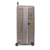 Beige TUMI suitcase on a white background