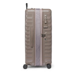 Beige TUMI suitcase on a white background