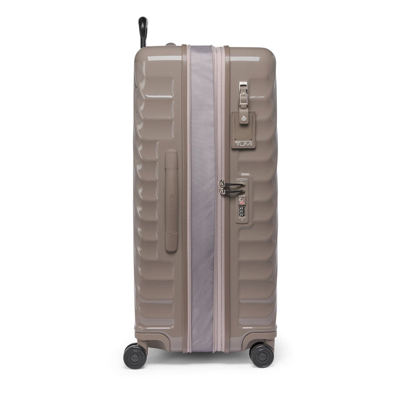 Beige TUMI suitcase on a white background