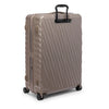 Beige TUMI suitcase with a black handle on a white background