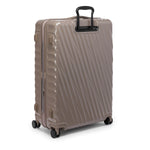 Beige TUMI suitcase with a black handle on a white background
