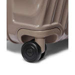 Close-up of a TUMI suitcase wheel on a white background