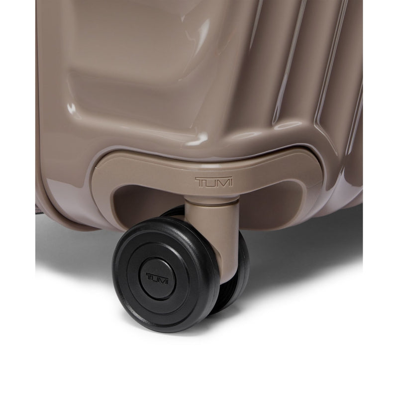 Close-up of a TUMI suitcase wheel on a white background
