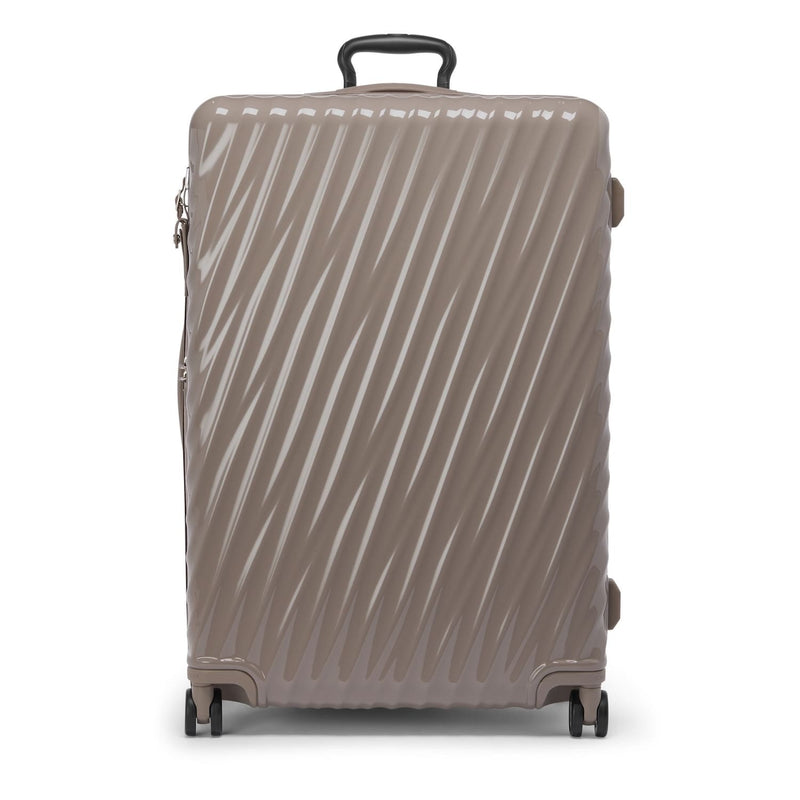 Beige TUMI suitcase with a pattern on a white background