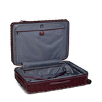 Open maroon TUMI suitcase with a visible brand logo on a white background