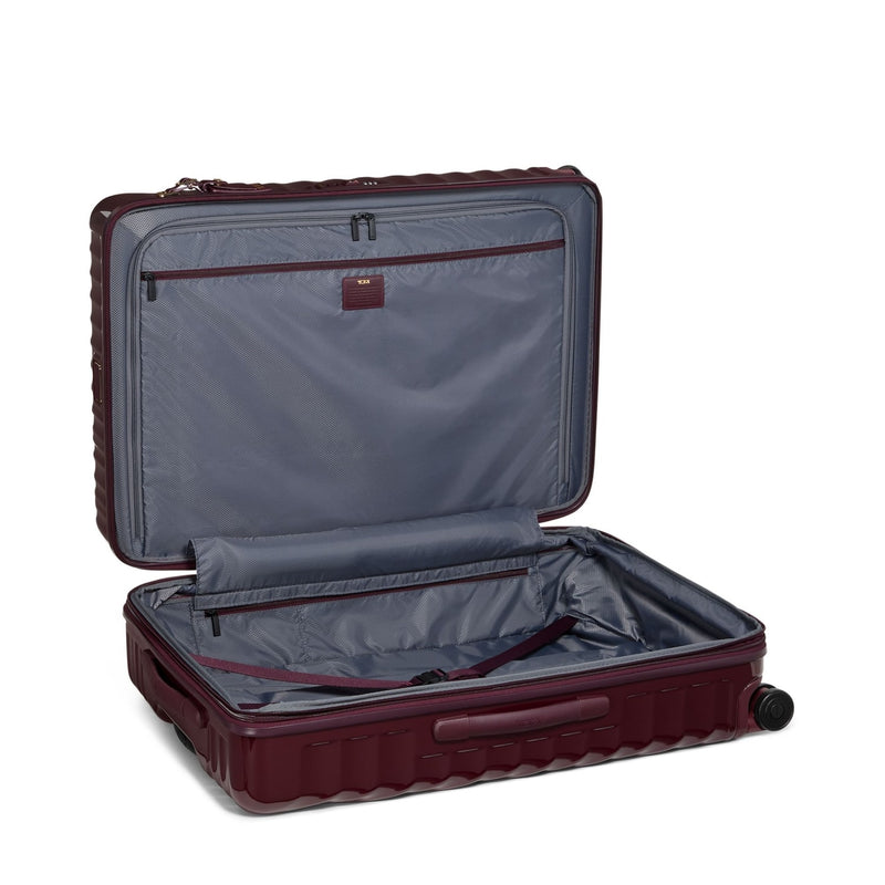 Open maroon TUMI suitcase with a visible brand logo on a white background