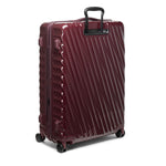 Maroon TUMI suitcase with black handle on a white background