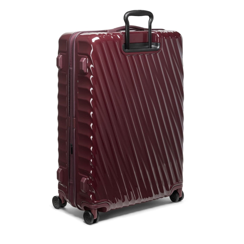 Maroon TUMI suitcase with black handle on a white background