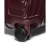 Close-up of a maroon TUMI suitcase with a visible brand logo on a white background