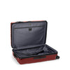 Open red TUMI suitcase on a white background