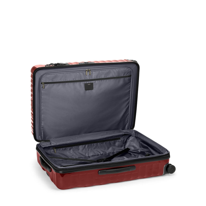 Open red TUMI suitcase on a white background