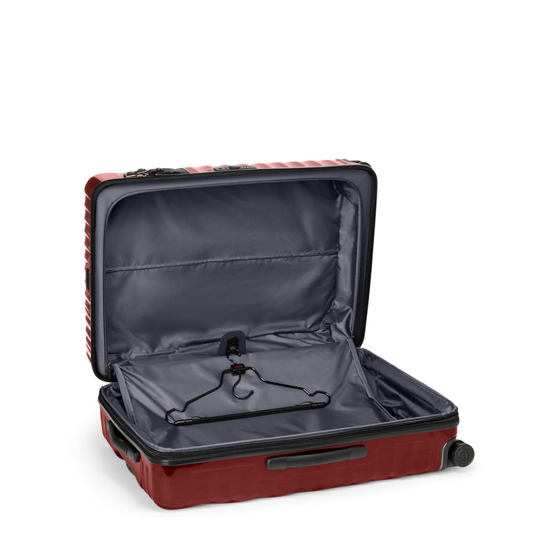 Open red TUMI suitcase on a white background