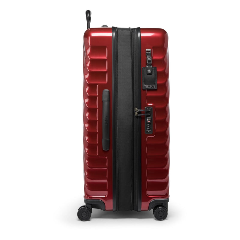 Red TUMI suitcase with black accents on a white background
